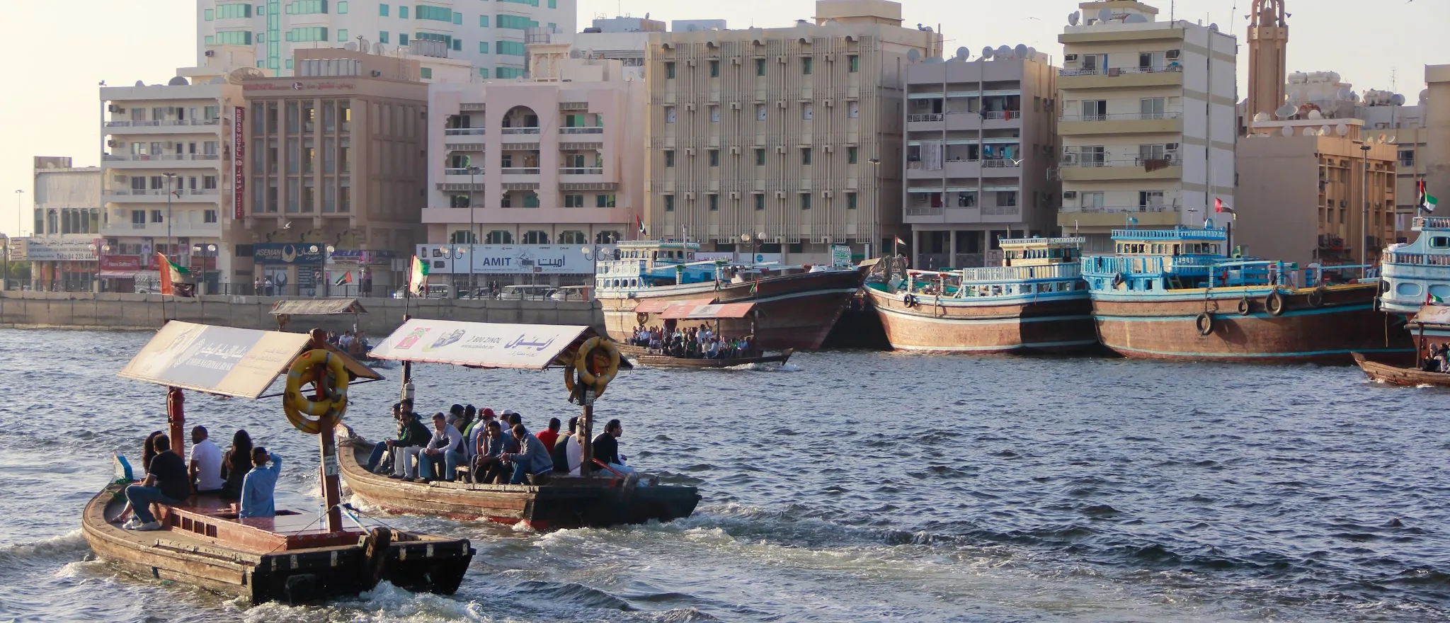 Traditional abras carrying passengers across Dubai Creek